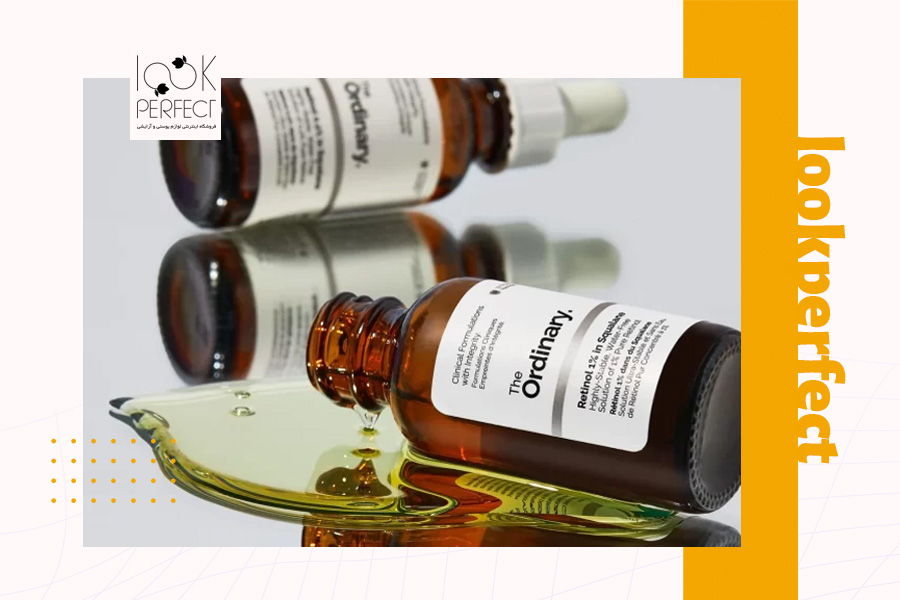 بطری باز شده رتینول اوردینری با سرمی زردرنگ که روی سطح شفاف ریخته شده است